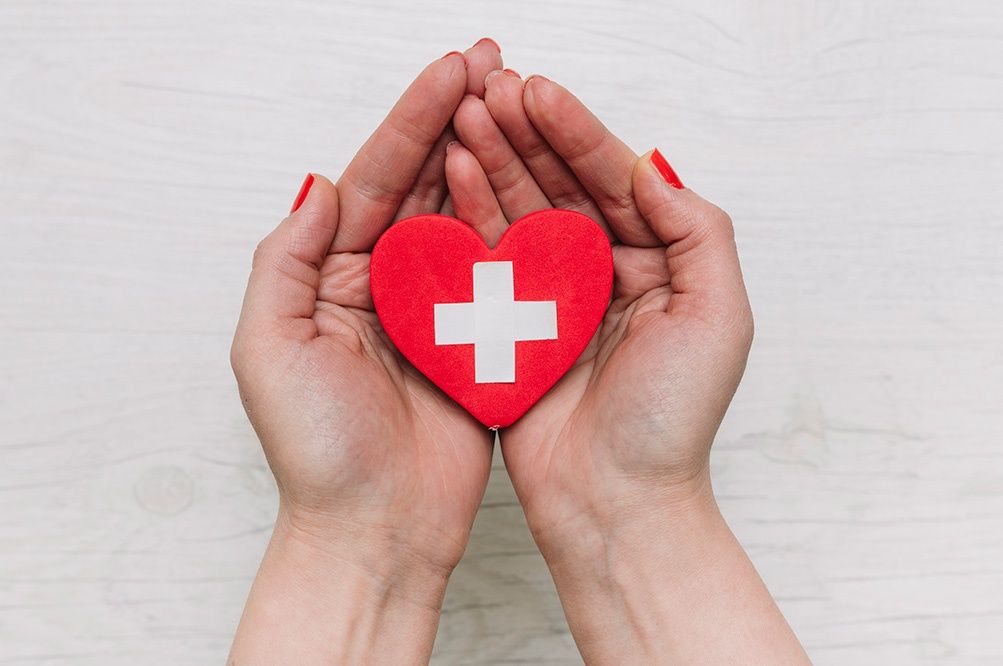 womans hands holding heart health 1000px
